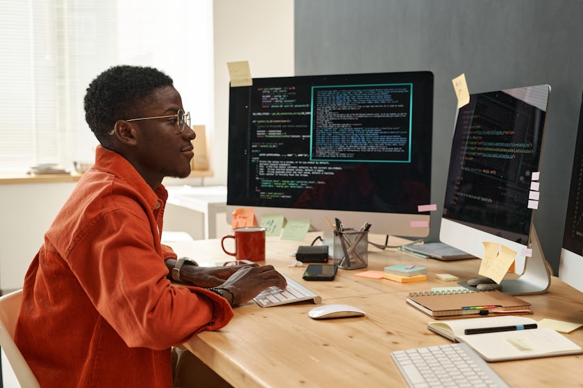 Man working remotely at a desk at his computer