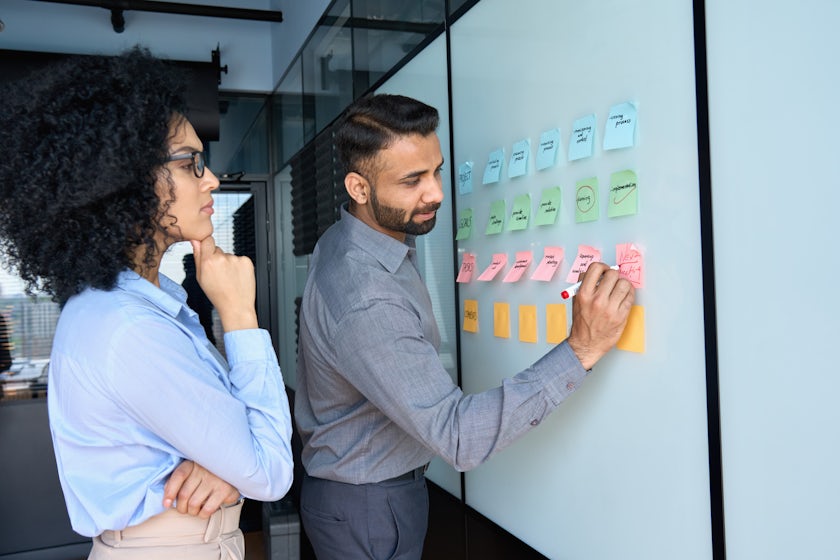 Two people at a white board