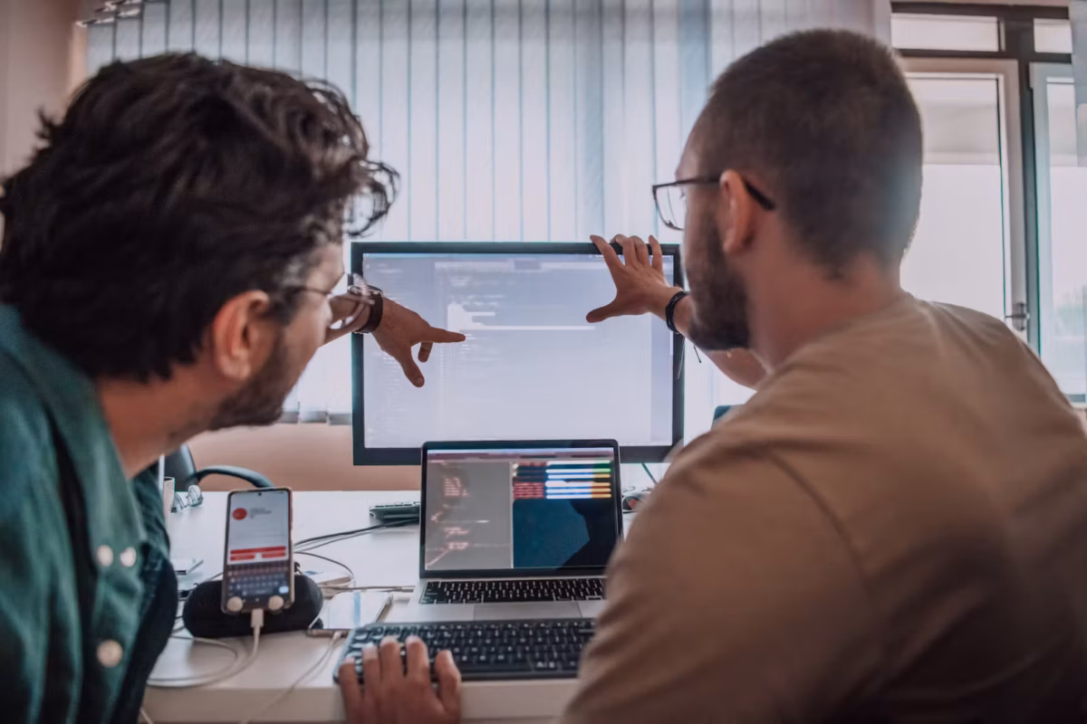 Two people design testing at computer